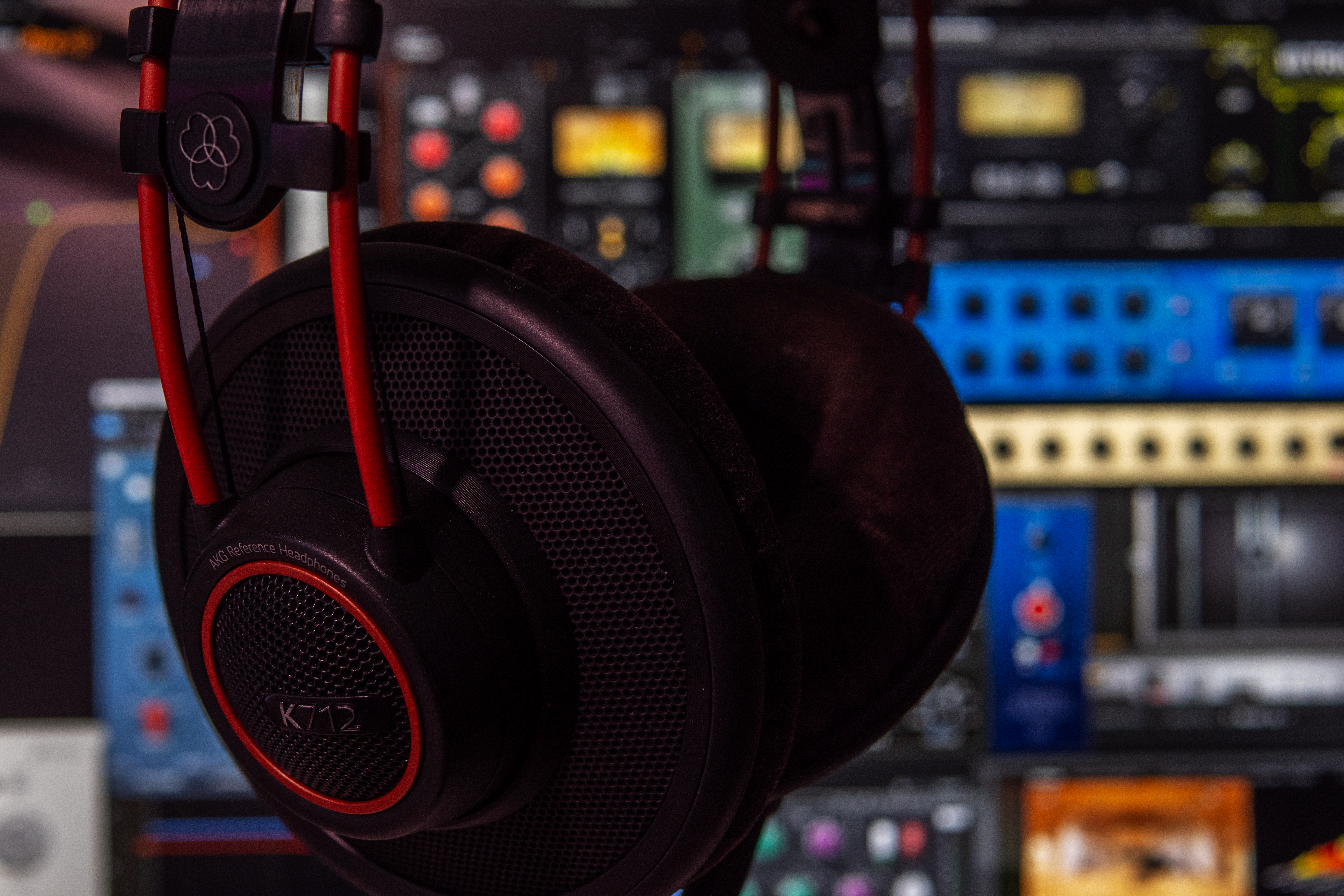 A close shot to the mixing desk with a monitor headset and software on screen